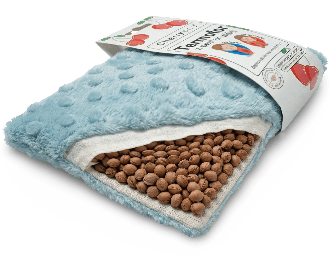 Przekrój Cherrypad® pokazujący warstwy: pokrowiec, wkład i pestki wiśni